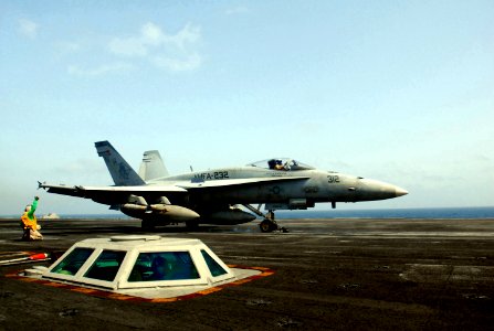 US Navy 070520-N-5484G-013 Aviation Boatswain's Mate Chief Andre Walton gives a thumbs up as an F-A-18 Hornet roars past aboard the nuclear-powered aircraft carrier USS Nimitz (CVN 68) photo