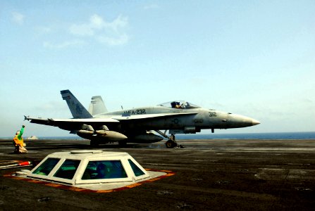 US Navy 070520-N-5484G-013 Aviation Boatswain's Mate Chief Andre Walton gives a thumbs up as an F-A-18 Hornet roars past aboard the nuclear-powered aircraft carrier USS Nimitz (CVN 68)