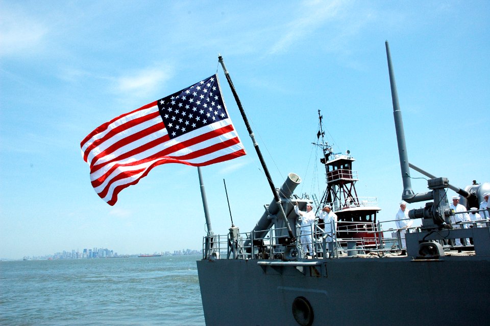 US Navy 070523-N-6812T-009 A Sailor hoists the National Ensign aboard USS San Jacinto (CG 56) as the guided missile cruiser moors at Staten Island's Stapleton Pier