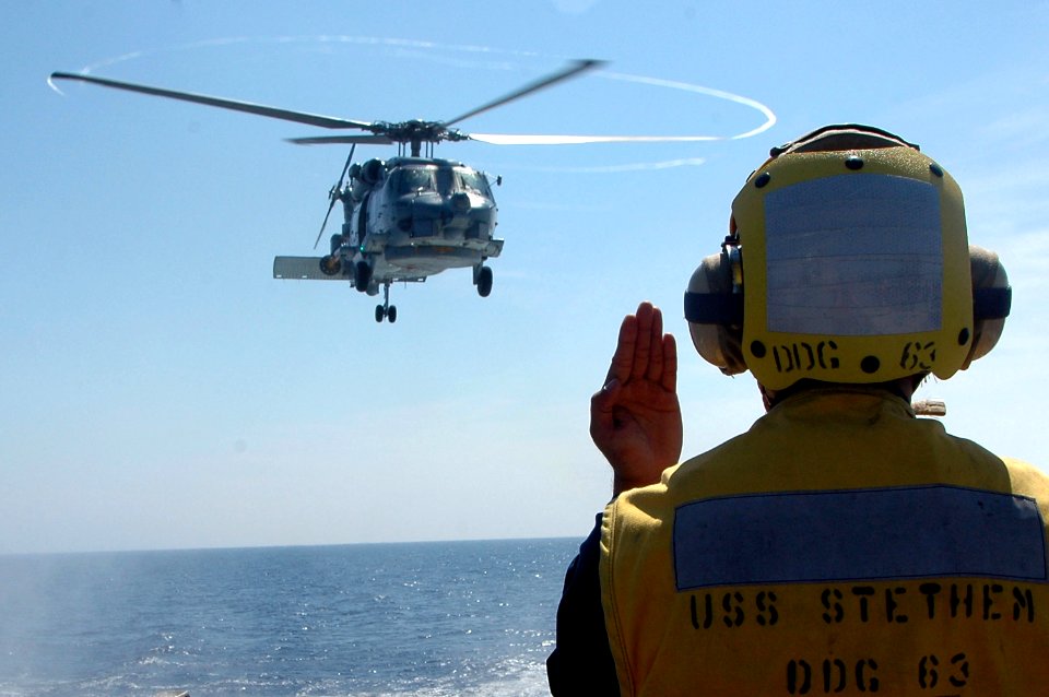 US Navy 070529-N-7883G-013 Boatswain's Mate 2nd Class Albert Sebastian from San Diego, directs an SH-60B Seahawk from Helicopter Anti-Submarine Squadron Light (HSL) 51 to land aboard USS Stethem (DDG 63)