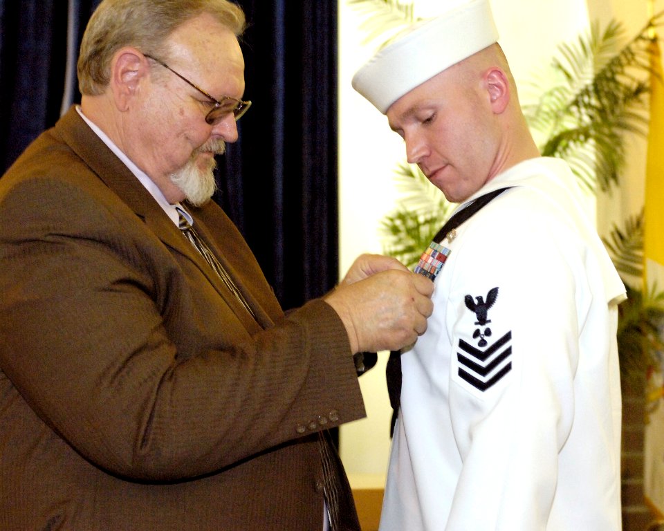 US Navy 070530-N-8467N-003 Dr. William C. Duke pins the Bronze Star on his son Machinist's Mate 1st Class Caleb S. Duke