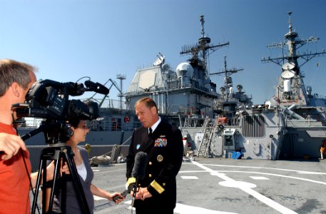 US Navy 070524-N-5459S-027 Commander, Standing NATO Maritime Group One (SNMG1), Rear Adm. Michael K. Mahon speaks to the local media on the flight deck of the guided-missile destroyer USS Mahan (DDG 72)