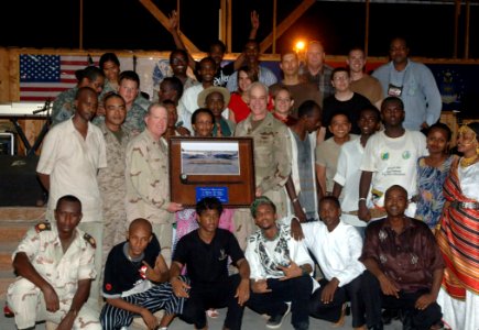 US Navy 070526-N-1003P-003 Rear Adm. James Hart, commander, Combined Joint Task Force-Horn of Africa, and Capt. Bob Wright, strategic communications office in charge, pose for a photo with all of the participants at the conclus photo