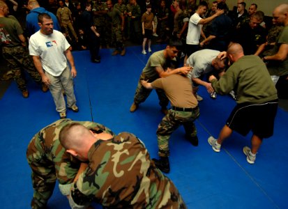 US Navy 070522-N-8923M-103 Sailors and Marines practice self-defense techniques under the supervision of coaches from the International Fighting League