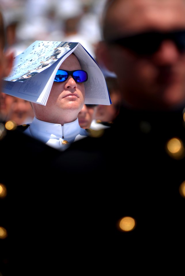 US Navy 070525-N-0696M-375 A member of the class of 2007 shields himself from an unusually hot spring day during the presentation of diplomas at the 2007 United States Naval Academy Graduation