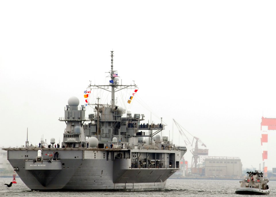 US Navy 070601-N-2638R-005 A large harbor tug follows alongside amphibious command ship USS Blue Ridge (LCC 19) as she departs Commander Fleet Activities for a scheduled summer underway period