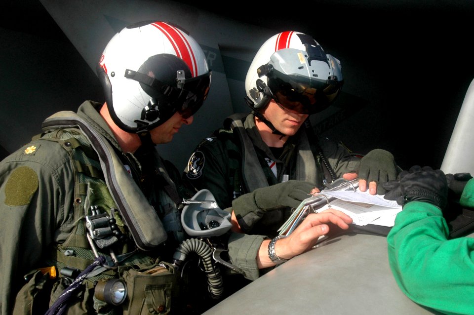 US Navy 070525-N-0890S-021 Lt. Cmdr. John Depree and Lt. j.g. David Dufault, both assigned to the Black Aces of Strike Fighter Squadron (VFA) 41, go over pre-flight checks prior to launch aboard nuclear-powered aircraft carrier