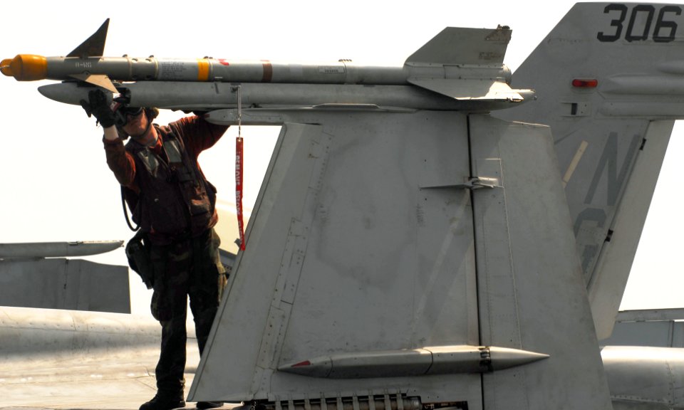 US Navy 070528-N-9928E-104 Aviation Ordnanceman 2nd Class Daniel Porter checks an AIM-9 Sidewinder missile for proper mounting on an F-A-18C Hornet, from the Blue Diamonds of Strike Fighter Squadron (VFA) 146, aboard USS John C
