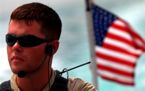 US Navy 070603-N-0684R-060 Visit, board, search and seizure (VBSS) team member Enginemen 3rd Class Blain Churchill, attached to the guided-missile destroyer USS Preble (DDG 88), drives a rigid hull inflatable boat