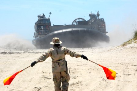 US Navy 070527-N-1831S-083 A Sailor assigned to Beachmaster two waves a Landing Craft Air Cushion ashore