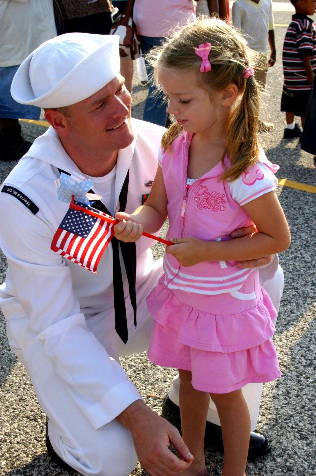 US Navy 070529-N-8544C-033 Electronics Technician 1st Class David Couch greets his four-year-old daughter during the homecoming for guided-missile destroyer USS The Sullivans (DDG 68)