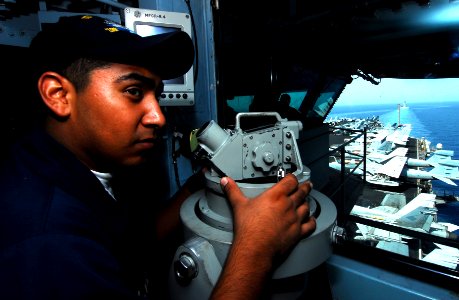 US Navy 070523-N-9928E-022 Seaman Alejandro Lopez stands lookout watch on the bridge during a transit through the Straits of Hormuz aboard the Nimitz-class aircraft carrier USS John C. Stennis (CVN 74)