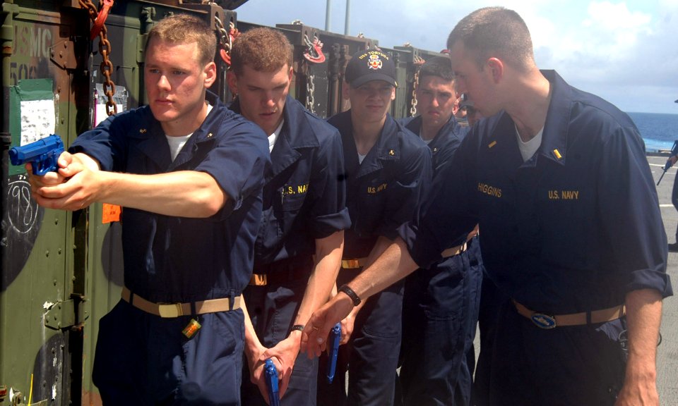 US Navy 070526-N-6710M-002 Ensign Michael H. Higgins trains a group of midshipmen on the flight deck of USS Tortuga (LSD 46) during their summer cruise