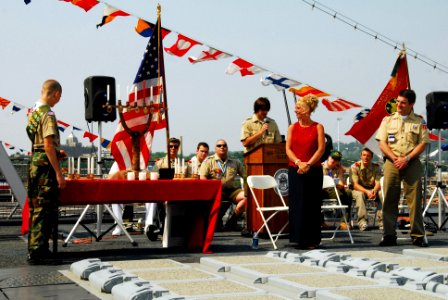 US Navy 070526-N-5758H-079 A new Eagle Scout lights 12 candles that symbolize each aspect of Scout Law, while his parents watch during an Eagle Scout ceremony aboard guided-missile destroyer USS Oscar Austin (DDG 79), as part o