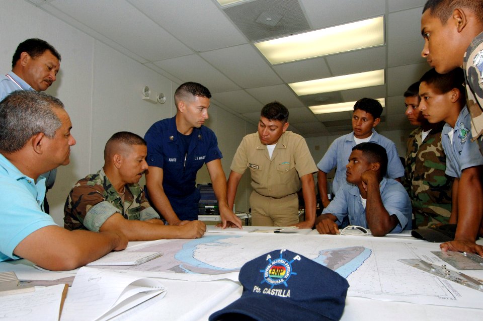US Navy 070530-N-0989H-003 Storekeeper 2nd Class Alfonso Anglada, Task Group 40.9 interpreter, explains symbols used on a chart to Honduran navy, Marine force, and port authority personnel during navigation subject matter excha