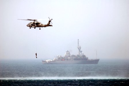 US Navy 070527-N-5484G-085 An SH-60F Seahawk helicopter, assigned to Helicopter Anti-Submarine Squadron (HS) 6, recovers one of its divers photo