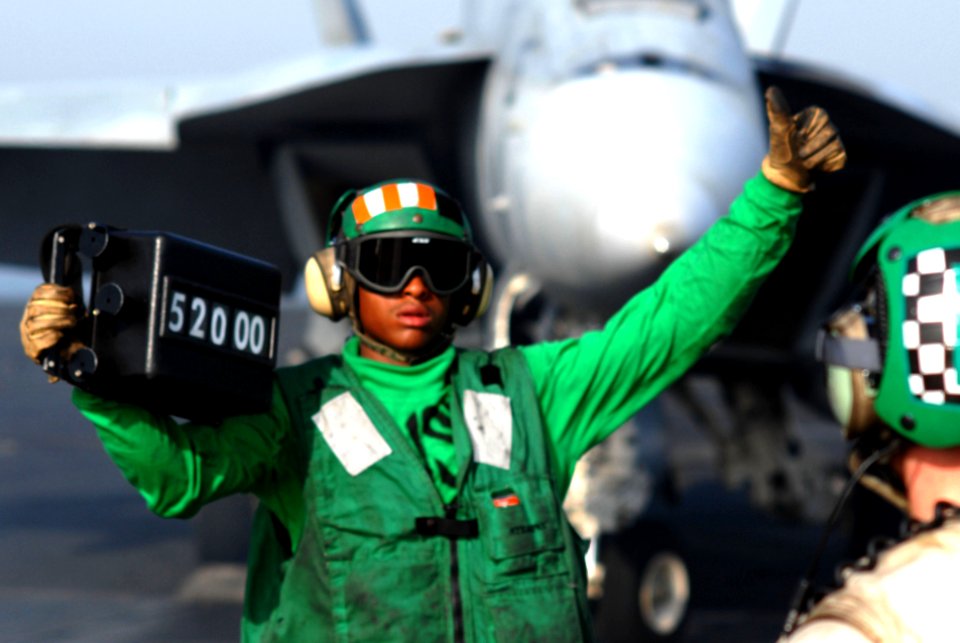 US Navy 070525-N-5484G-041 Aviation Boatswain's Mate Airman Michael Selvey signals that he has completed his job confirming the weight of an F-A-18F Super Hornet aboard nuclear-powered aircraft carrier USS Nimitz (CVN 68)