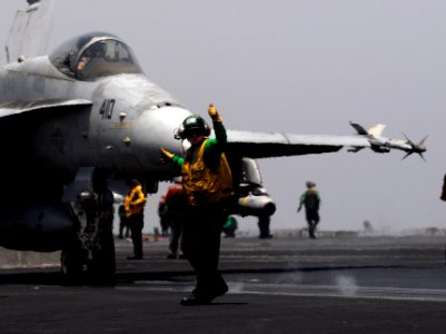 US Navy 070531-N-3038W-036 Catapult safety observer, Aviation Boatswain's Mate (Equipment) 1st Class Daniel Brandau, signals that an F-A-18C Hornet assigned to the Argonauts of Strike Fighter Squadron (VFA) 147 is ready for lau