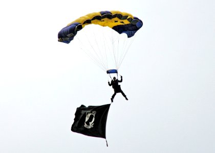 US Navy 070601-N-8497H-060 A member of the U.S. Navy Parachute Team, known as Leap Frogs, jumps into Bishop McGuiness Catholic High School photo
