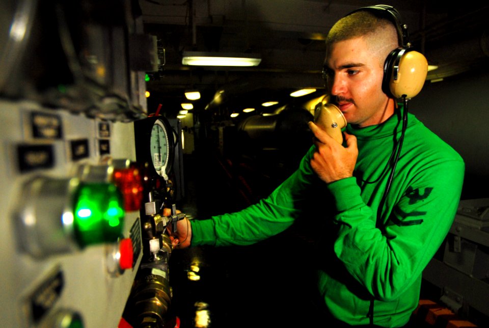 US Navy 070529-N-2659P-066 Aviation Boatswain's Mate (Equipment) 2nd Class Joseph Mikes from air department's launch and recovery division charges an arresting gear engine to recover aircraft aboard Nimitz-class aircraft carrie