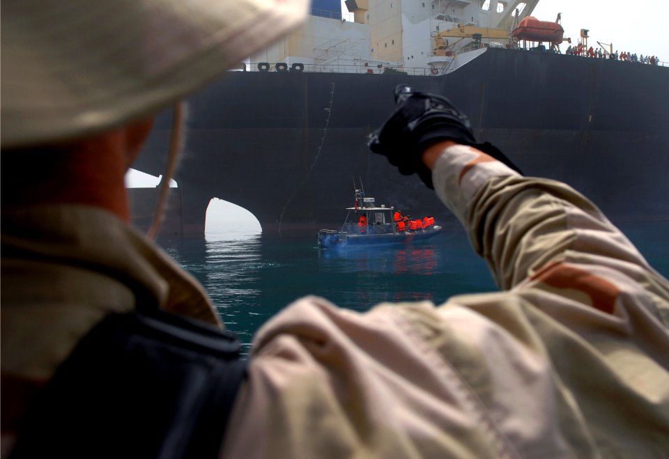 US Navy 070603-N-0684R-123 Lt. j.g. Tom Hennessey, officer in charge of guided-missile destroyer USS Preble's (DDG 88) visit, board, search and seizure (VBSS) team, attempts to count personnel aboard an oil tanker before an Ira