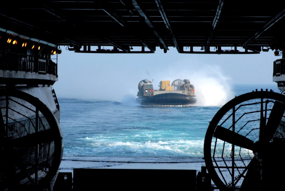US Navy 070530-N-5033P-042 A landing craft air cushion (LCAC) returns to the well deck of amphibious assault ship USS Kearsarge (LHD 3) after landing troops and supplies at Camp Lejune