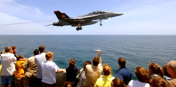 US Navy 070602-N-5345W-173 Guests gathered in the bow catwalks get an up-close look as an F-A-18F Super Hornet