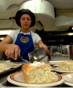 US Navy 070609-N-8923M-035 Culinary Specialist 3rd Class Hilda Alcantara prepares dessert plates in the bake shop aboard Nimitz-class aircraft carrier USS Harry S. Truman (CVN 75)