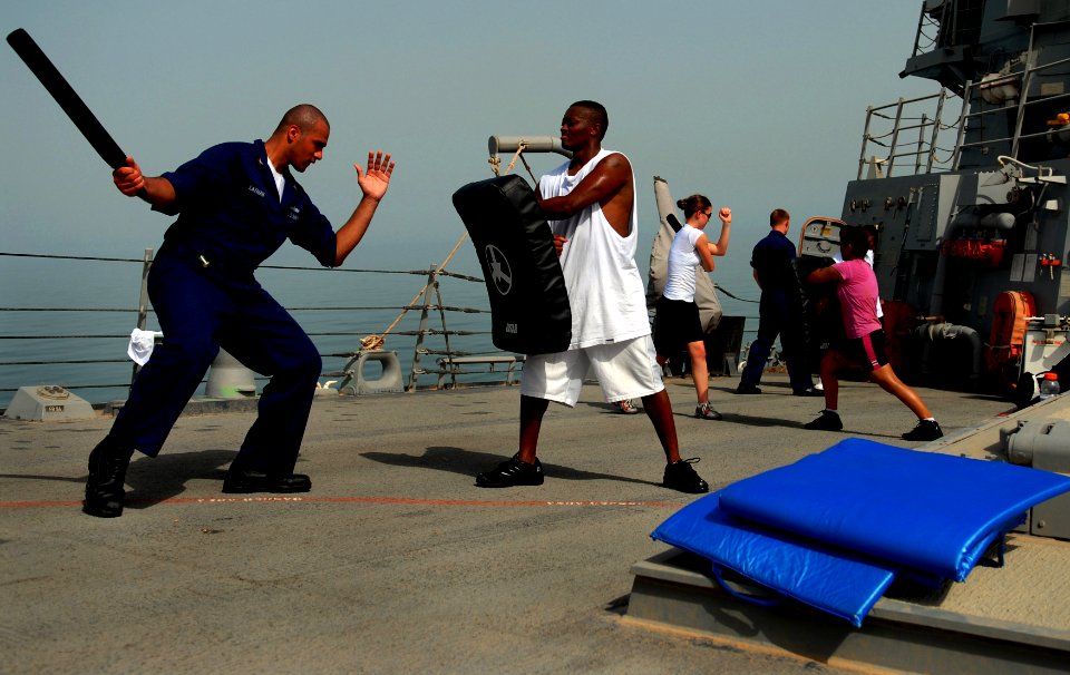 US Navy 070602-N-0684R-154 Operations Specialist 2nd Class Stephen Layman practices proper baton striking techniques during force protection training on the forecastle aboard guided-missile destroyer USS Preble (DDG 88)