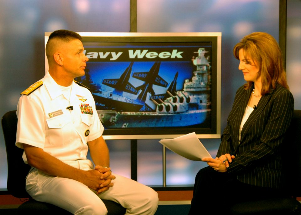 US Navy 070604-N-8497H-030 Director of Global Operations (J3) United States Strategic Command, Rear Adm. Doug McClain, talks to (KFOR) Channel Four News's Ali Meyer about the Navy and events during Oklahoma Navy Week