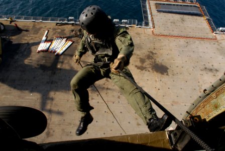 US Navy 070606-N-2659P-160 Lt. Bob Marsh fast ropes from an HH-60H Seahawk attached to the Eightballers of Helicopter Anti-Submarine Squadron (HS) 8 during a exercise over the amphibious assault ship USS Bonhomme Richard (LHD 6