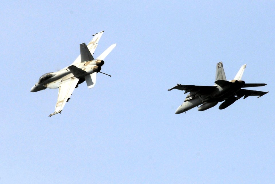 US Navy 070606-N-3038W-167 An F-A-18F Super Hornet attached to the Black Knights of Strike Fighter Squadron (VFA) 154 breaks out of formation high above the Nimitz-class aircraft carrier USS John C. Stennis (CVN 74)