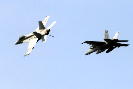 US Navy 070606-N-3038W-167 An F-A-18F Super Hornet attached to the Black Knights of Strike Fighter Squadron (VFA) 154 breaks out of formation high above the Nimitz-class aircraft carrier USS John C. Stennis (CVN 74)
