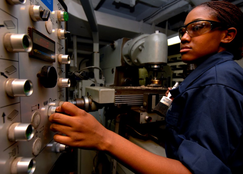 US Navy 070611-N-8923M-019 Machinery Repairman Fireman Domonique Roberson adjusts measurements while making a sounding cap in the machine shop aboard Nimitz-class aircraft carrier USS Harry S. Truman (CVN 75)