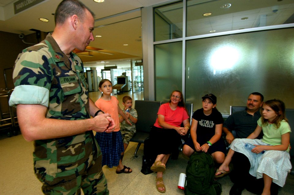 US Navy 070612-N-2456S-052 Lt. Cmdr. Patrick Fulgham, executive officer of Maritime Civil Affairs Group (MCAG) 2, speaks to the family of Electronics Technician 1st Class Darryl Youngblood about the Sailor's two-week depl