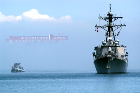 US Navy 070612-N-5253W-002 Arleigh Burke-class guided-missile destroyer USS Curtis Wilbur (DDG 54) emerges from the haze as she returns to the forward-deployed operating base Commander Fleet Activities Yokosuka following a sche