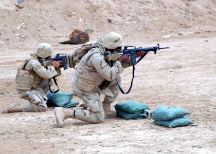 US Navy 070603-N-3560G-022 Equipment Operator 3rd Class Mathew Roy (left) and Culinary Specialist 3rd Class Anthony Foster of Naval Mobile Construction Battalion (NMCB) 4 practice their sharp shooting skills with the M16-A serv