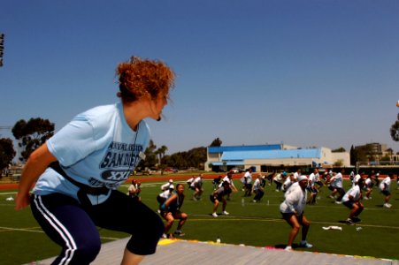 US Navy 070607-N-2420K-001 Morale, Welfare, and Recreation (MWR) fitness instructor Mariam Marquez leads a group of Sailors and civilians during a two hour Aerobathon held at Admiral Prout Field photo