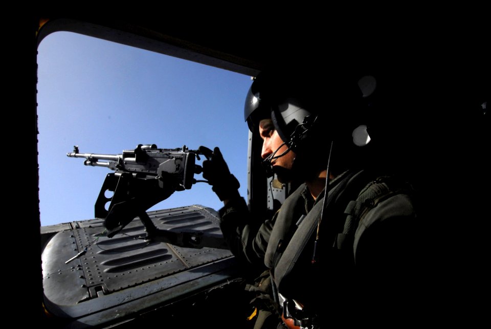 US Navy 070604-N-9928E-105 Aviation Warfare Systems Operator 2nd Class Bryan stands by a .50 caliber machine gun mount on an HH-60H Seahawk attached to Helicopter Anti-Submarine Squadron (HS) 8