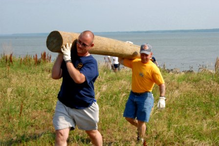 US Navy 070606-N-6724S-027 Aviation Support Equipment Technician 1st Class Manfred Gooden (left) and Senior Chief Machinist's Mate Kenneth Cowen carry away a piling