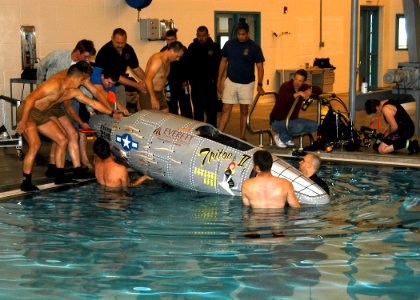 US Navy 070613-N-6247M-013 Sailors from Naval Air Station Whidbey Island's Aviation Survival Training Center (ASTC) and students from Everett Community College prepare to test a small submarine