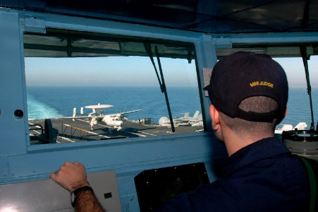 US Navy 070607-N-0890S-001 Lt. Matthew Sklerov watches from the pilothouse as an E-2C Hawkeye, assigned to the Wallbangers of Carrier Early Warning Squadron (VAW) 117, performs a touch-and-go aboard nuclear-powered aircraft car