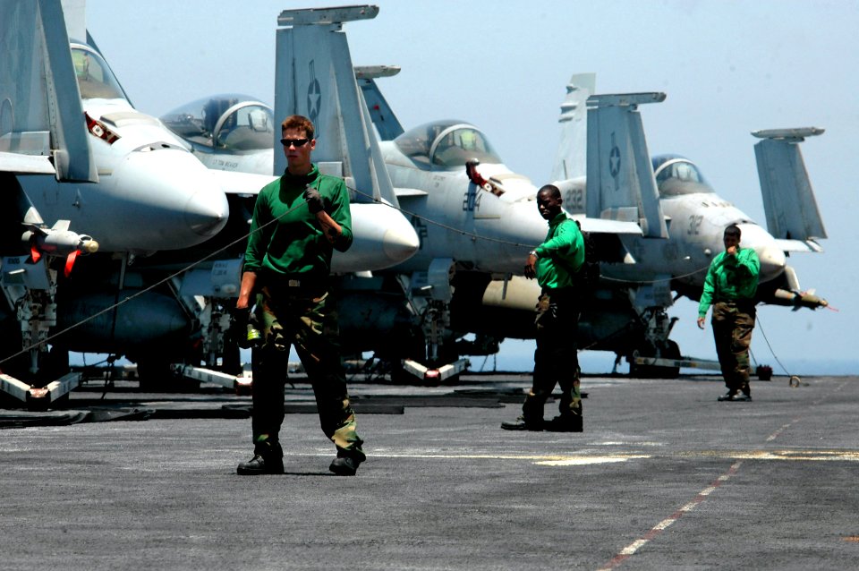 US Navy 070614-N-9760Z-019 Sailors hold a line to prevent personnel from crossing into the catapult area while conducting regular maintenance on the flight deck aboard nuclear-powered aircraft carrier USS Nimitz (CVN 68)