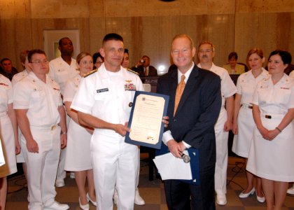 US Navy 070605-N-8497H-031 Director of Global Operations (J3) United States Strategic Command, Rear Adm. Doug McClain receives the Proclamation from Mayor Mick Cornett, declaring June 1-10 Oklahoma Navy week