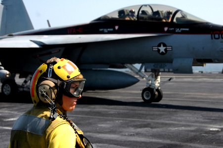 US Navy 070615-N-0890S-044 Lt. Regina Rogers watches as an F-A-18F Super Hornet taxis to the catapult aboard nuclear-powered aircraft carrier USS Nimitz (CVN 68)