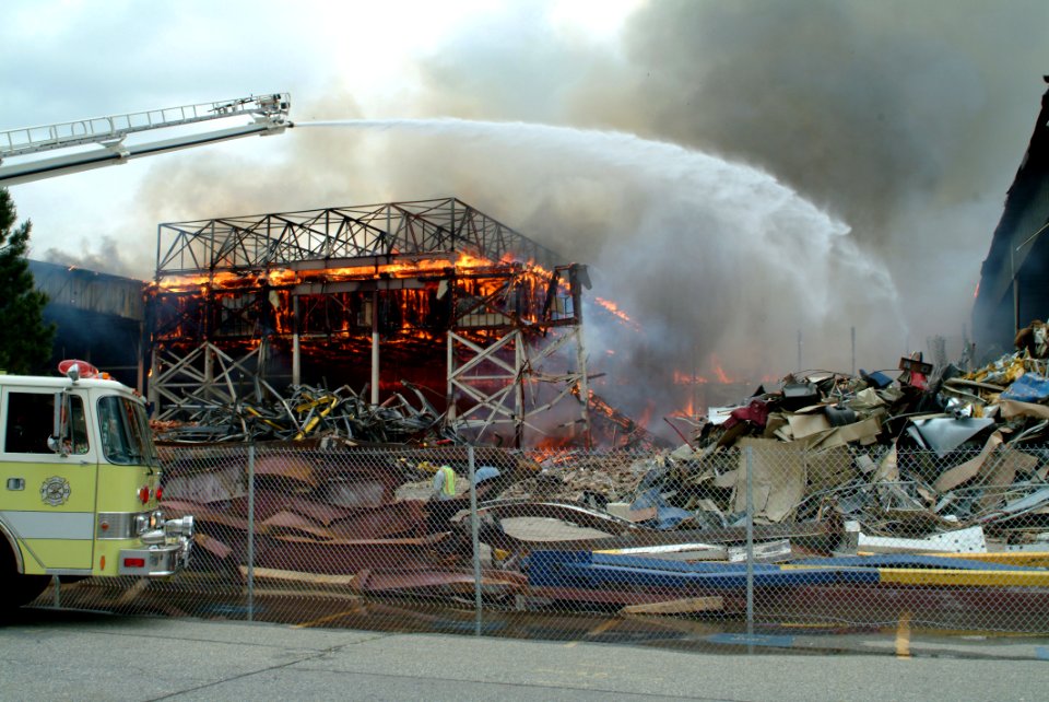 US Navy 070613-N-0411D-024 Fire trucks spray water on Hangar One onboard Naval Air Station Brunswick as it burns
