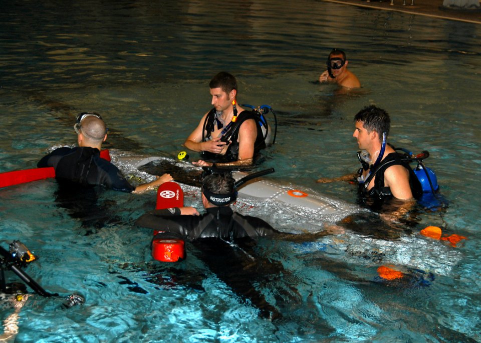 US Navy 070613-N-6247M-019 Sailors from Naval Air Station Whidbey Island's Aviation Survival Training Center (ASTC) and students from Everett Community College test a small submarine