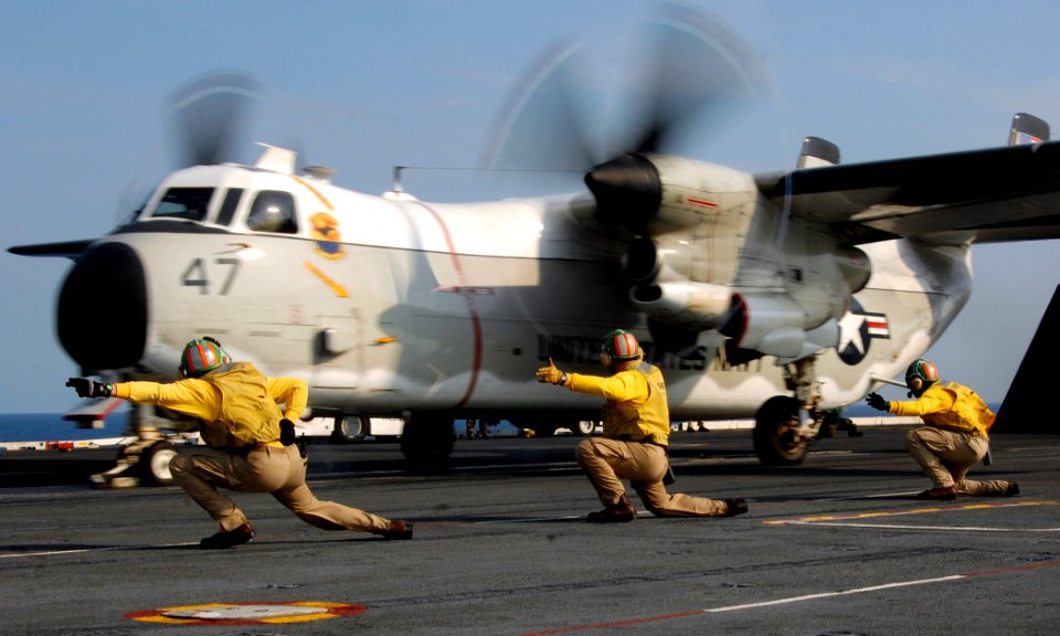 US Navy 070611-N-8923M-092 From left to right, Lt. Cmdr. Todd Holbeck, Lt. Cmdr. Alan D'Jock and Lt. Cmdr. Lindsey Graves give the final signal to launch a C-2 Greyhound from USS Harry S. Truman