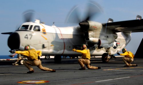US Navy 070611-N-8923M-092 From left to right, Lt. Cmdr. Todd Holbeck, Lt. Cmdr. Alan D'Jock and Lt. Cmdr. Lindsey Graves give the final signal to launch a C-2 Greyhound from USS Harry S. Truman photo