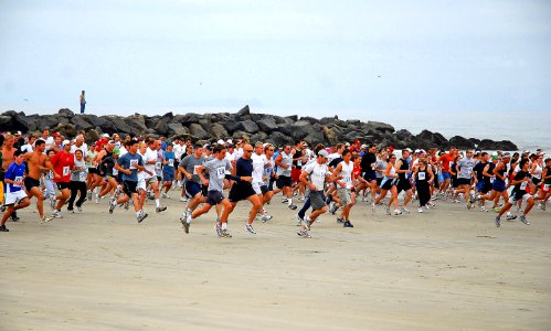 US Navy 070617-N-4774B-163 Runners pass the starting line of the 8.2 mile Low Tide Ride and Stride race from Imperial Beach-to-Coronado, California